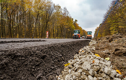 Close view on the road repairing. Roller working on the new road construction site